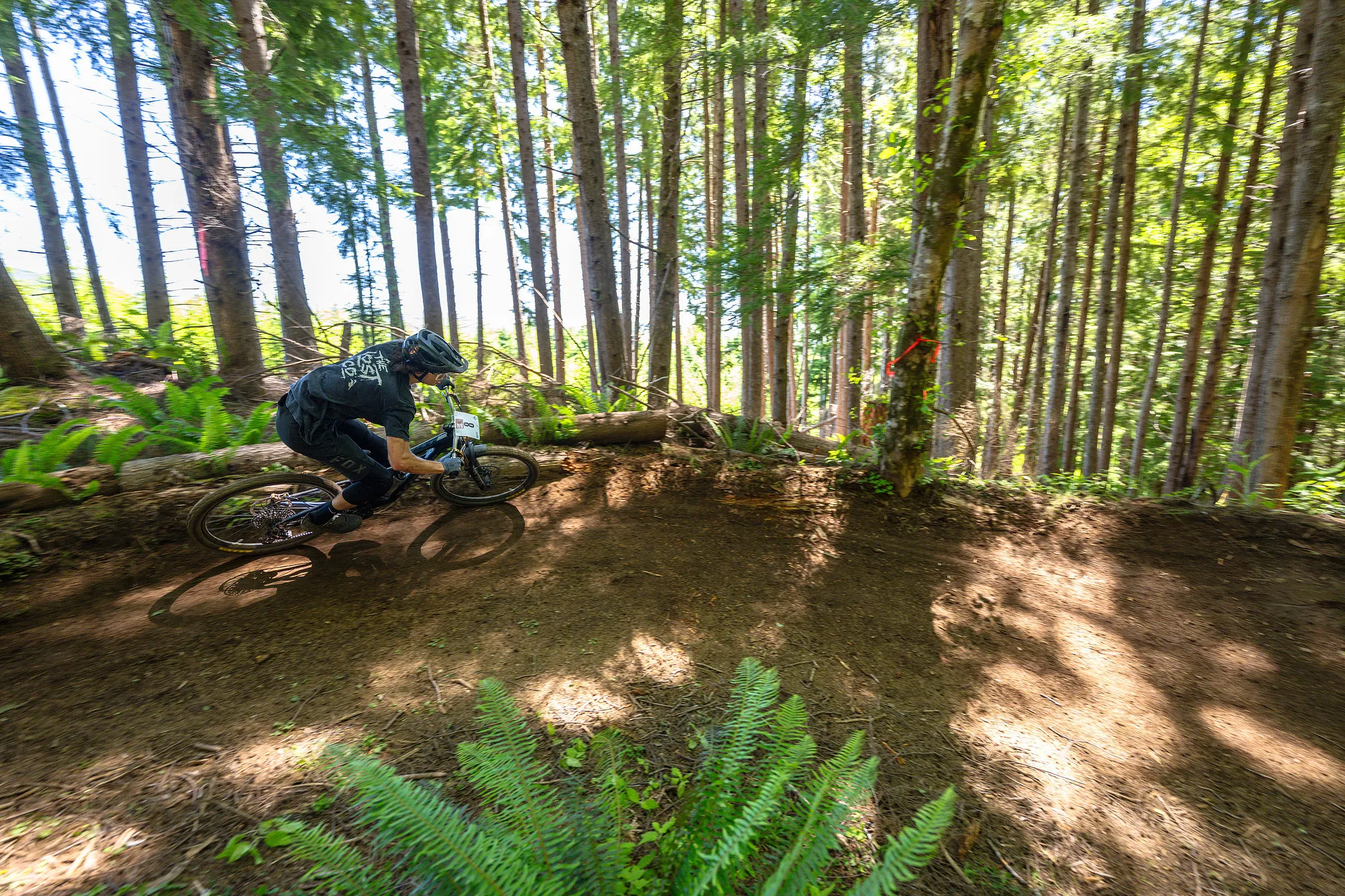 Enduro racer carving through the forest