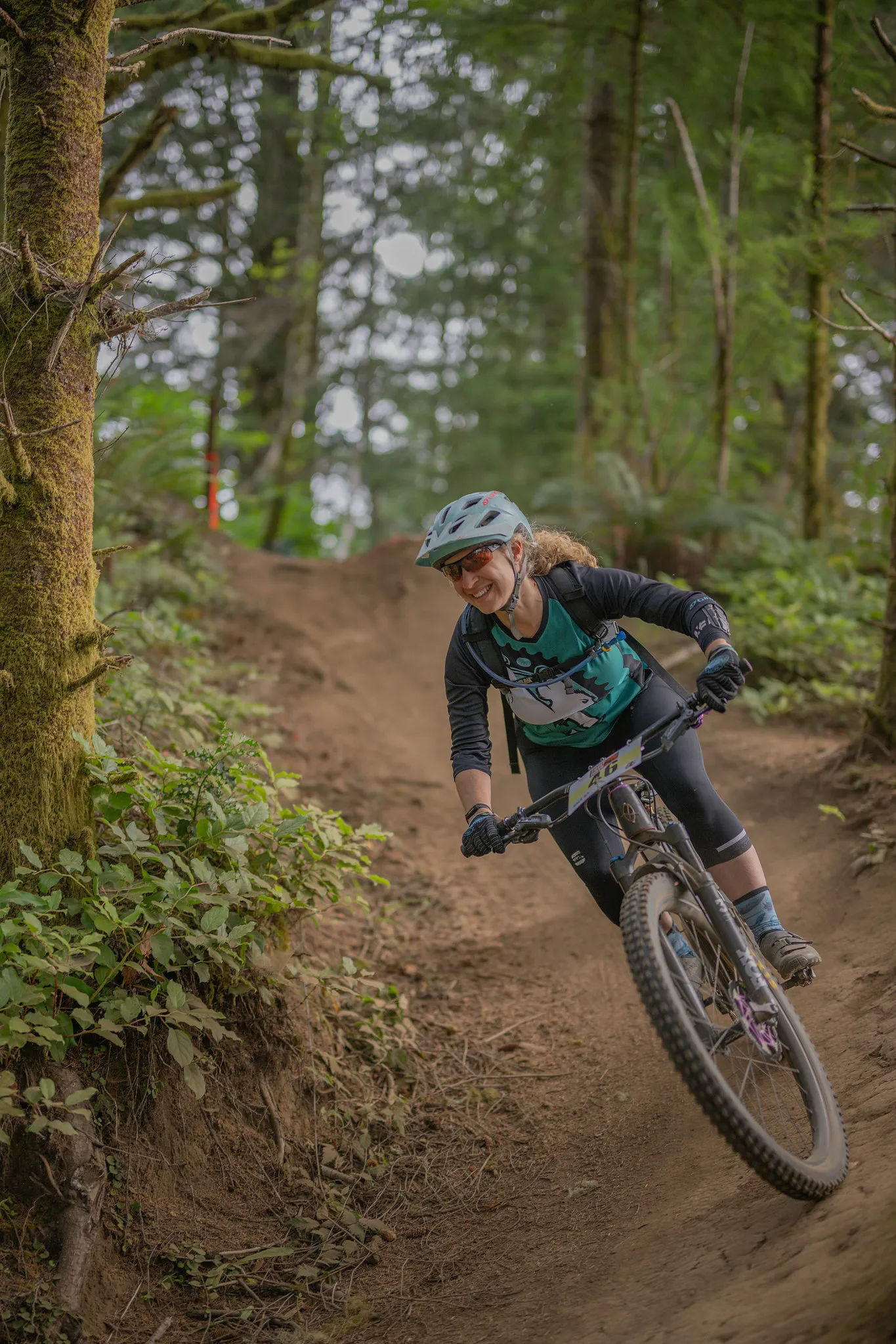 Racer descending a forest trail