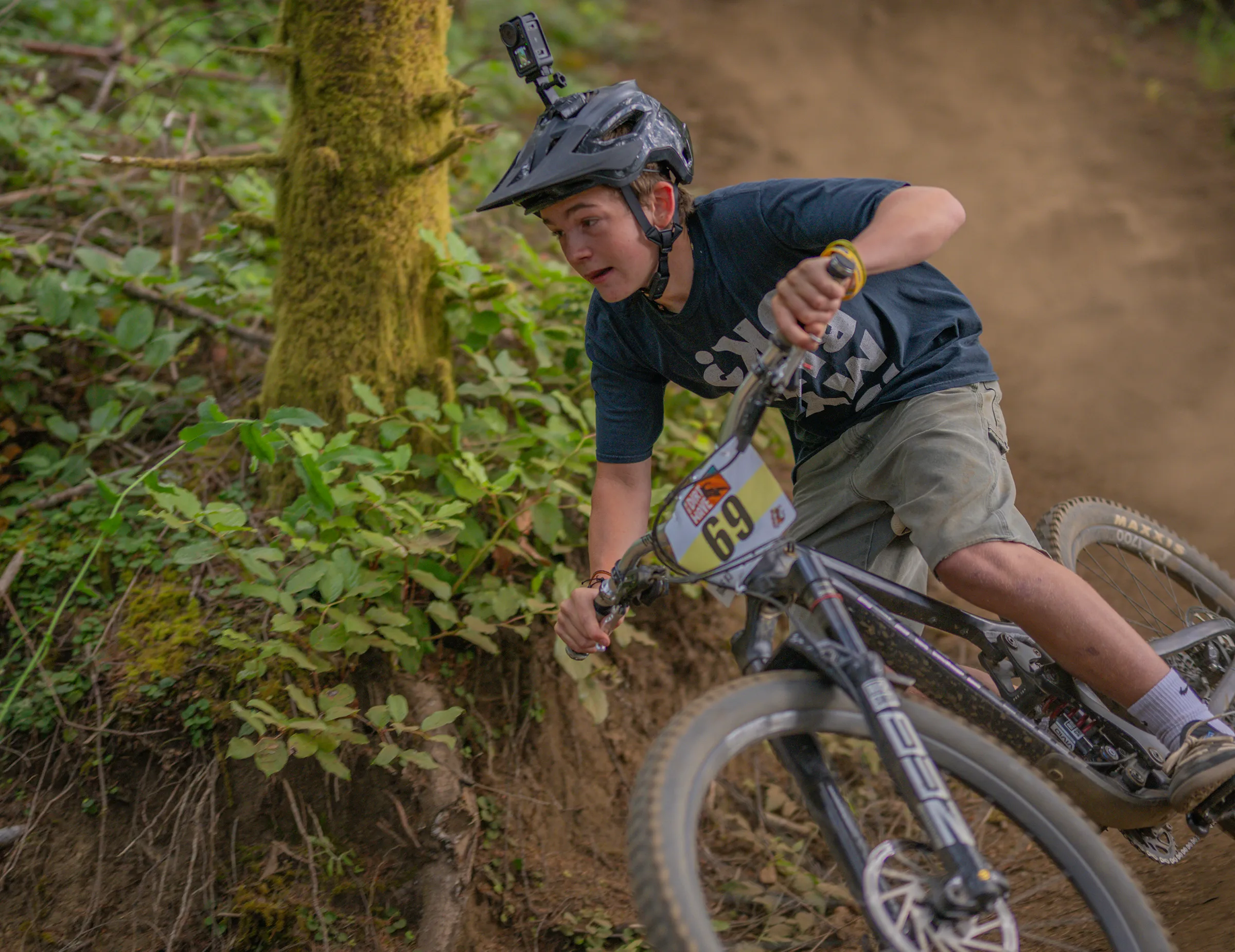 A young racer carving a bermed corner at the Big Creek Trails in Newport during Ride the Dirt Wave